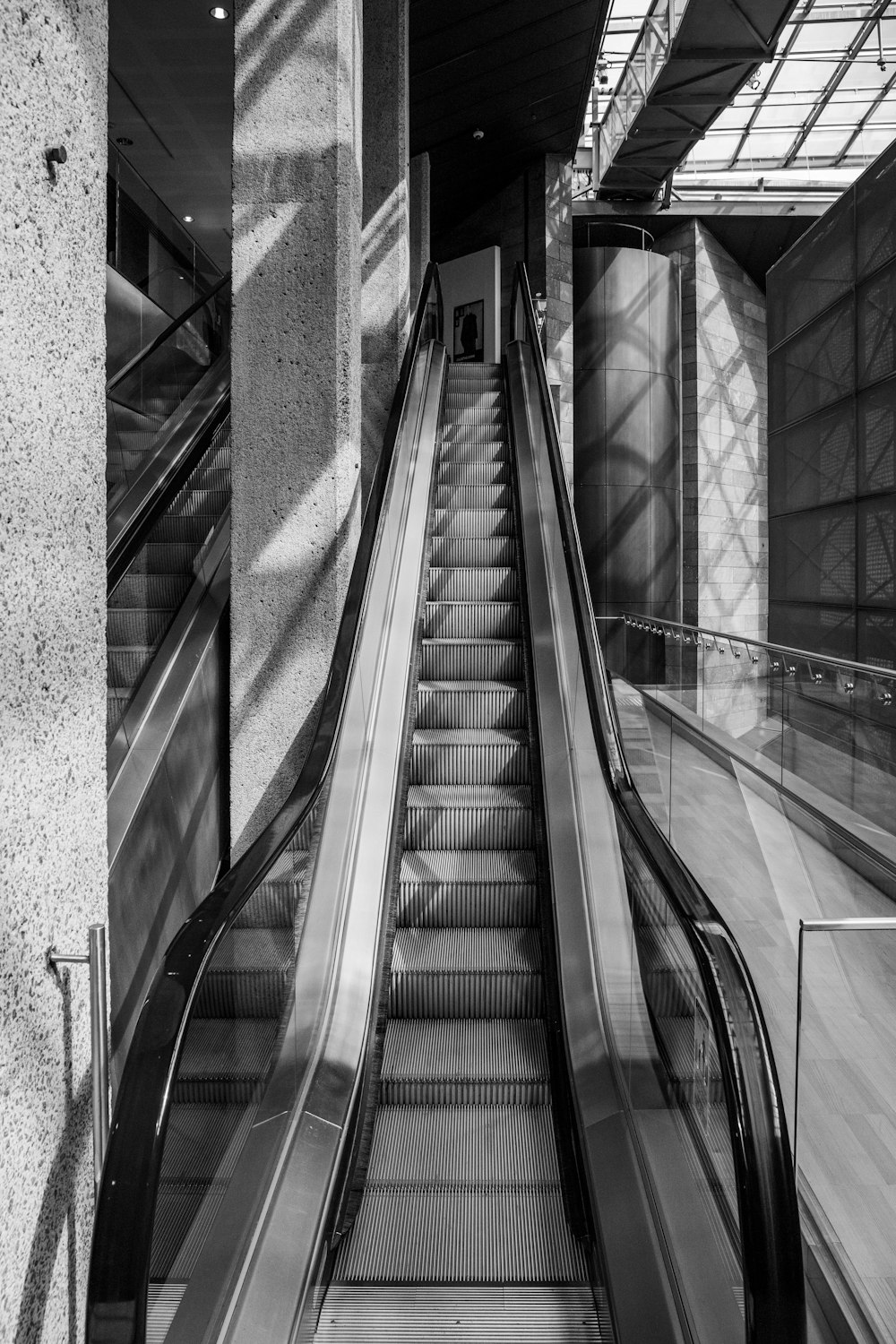 grayscale photo of a escalator