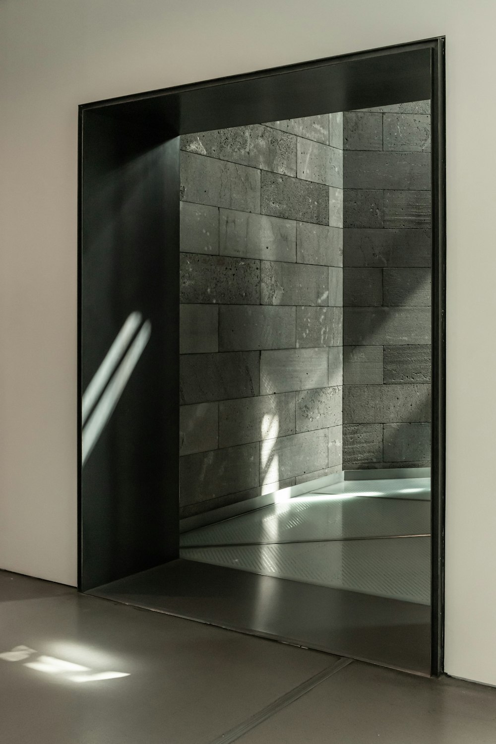 black framed glass door near white wall