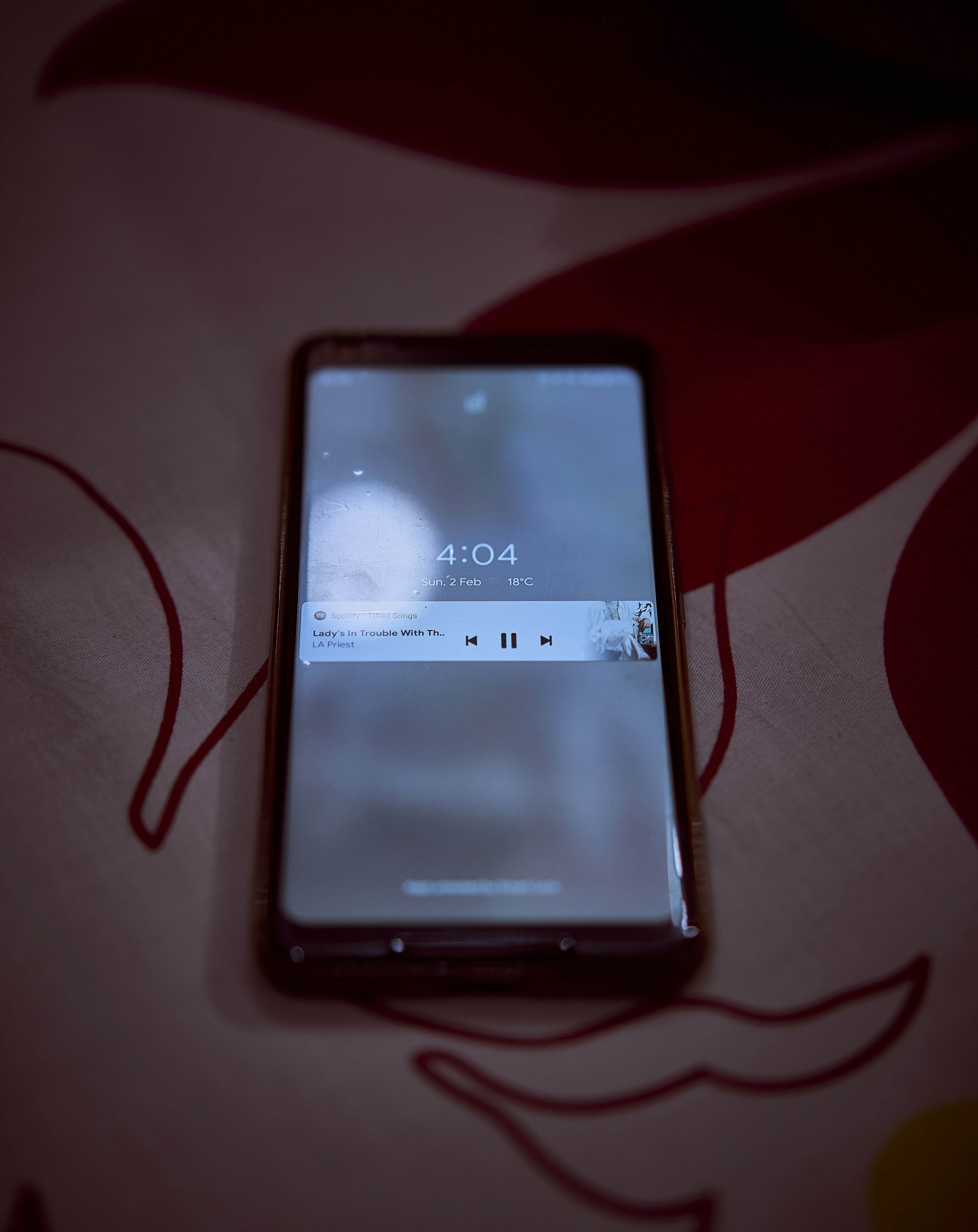 An Android phone playing a song on Spotify