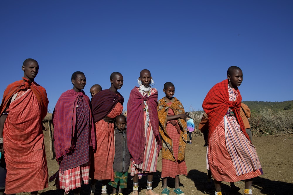 group of people standing on green grass field during daytime