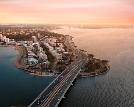 A high-resolution aerial shot capturing Miami's bustling commercial waterfront district at sunset.