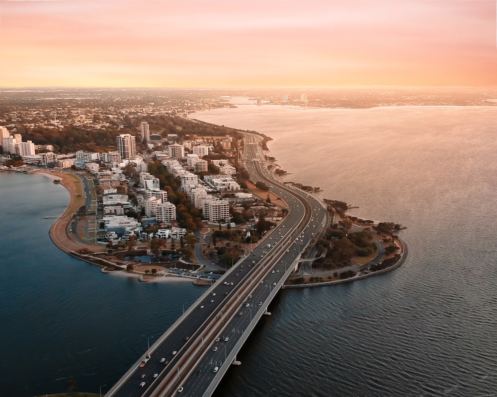 aerial view of city buildings near body of water during daytime