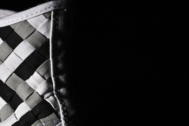 Close-up of a pastel checkered tablecloth showcasing fine stitching and durable fabric texture