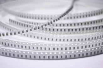 Close-up of a plastic base carrier tape showing detailed texture and structure.