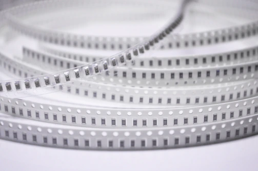 Close-up of a plastic base carrier tape showing detailed texture and structure.