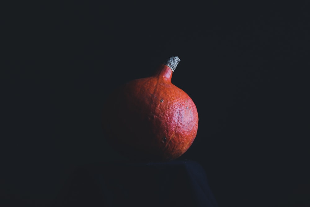 red round fruit on black background