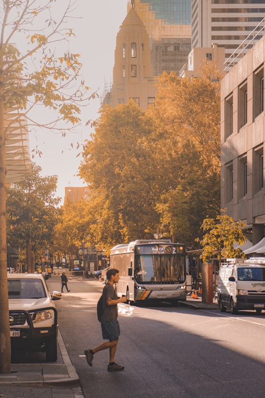 man in black jacket and black pants walking on sidewalk during daytime in Perth WA Australia