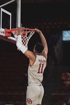 man in white and red basketball jersey shirt holding basketball