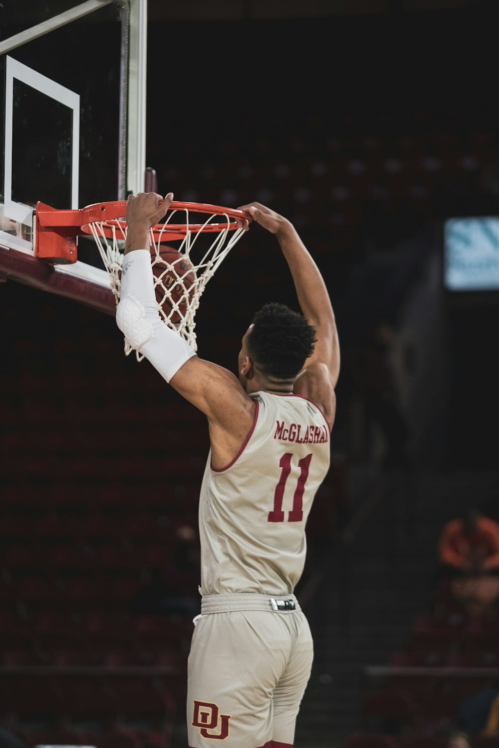 man in white and red basketball jersey shirt holding basketball