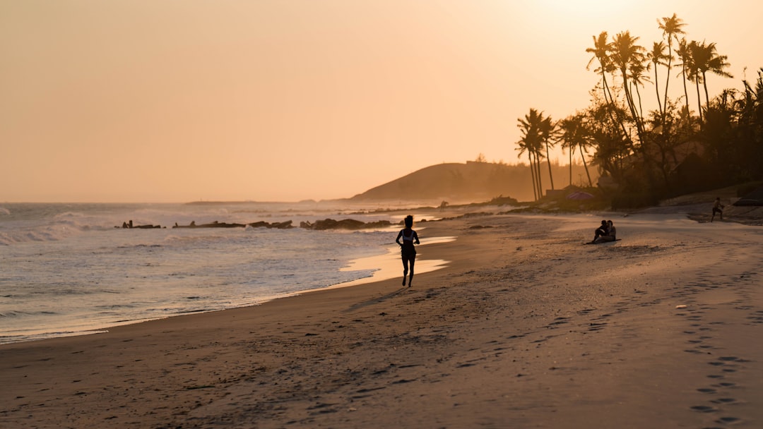 person walking on beach during daytime