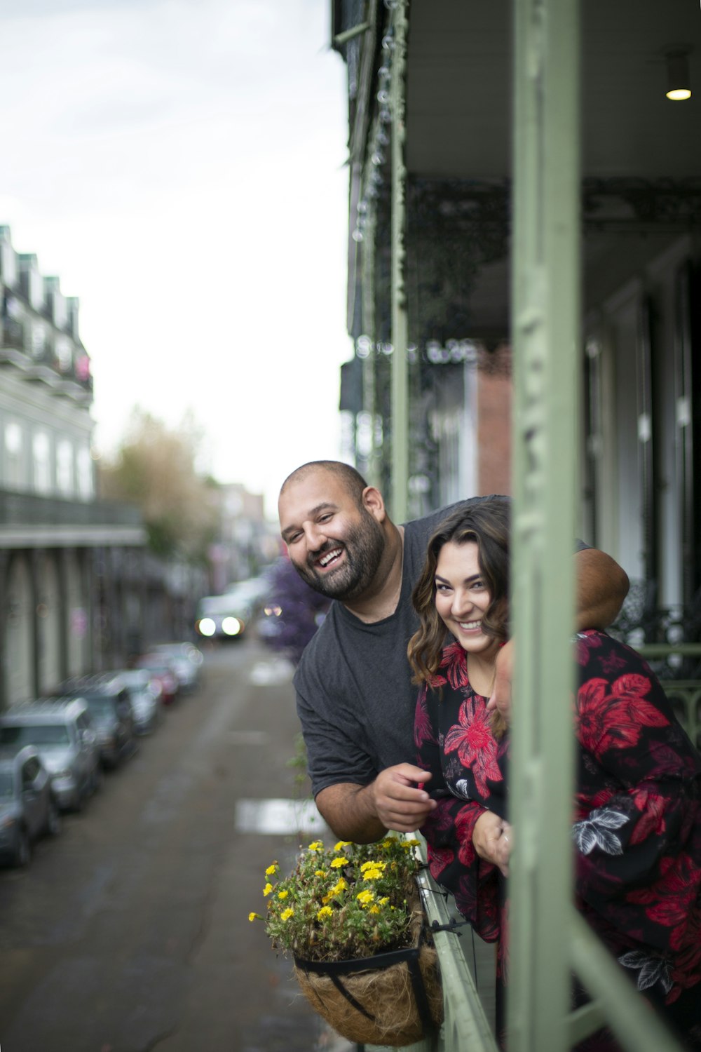 man in black crew neck t-shirt hugging woman in purple long sleeve shirt