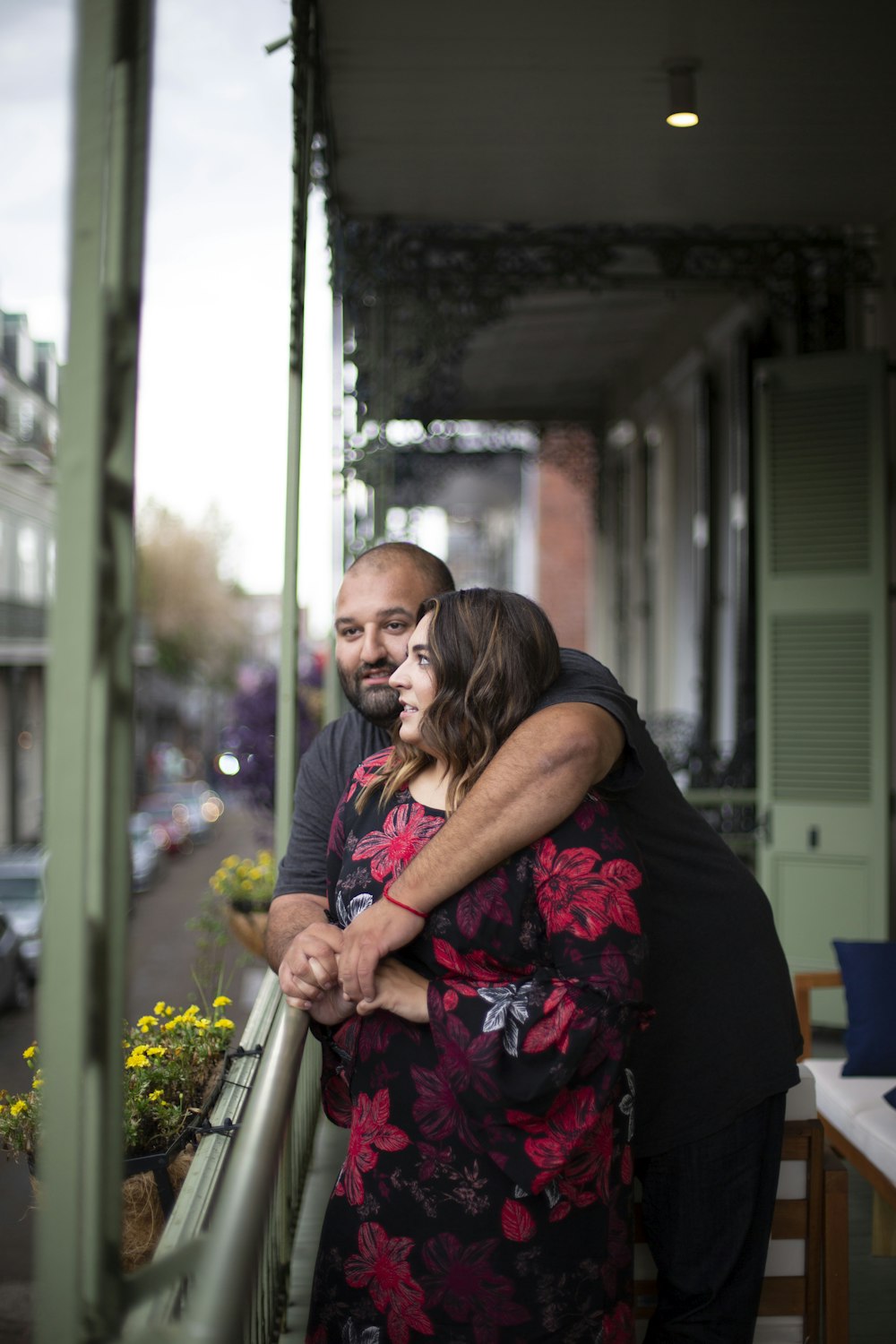 woman in black and pink floral dress hugging man in black t-shirt