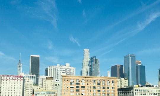 white and brown concrete building under blue sky during daytime in Los Angeles United States