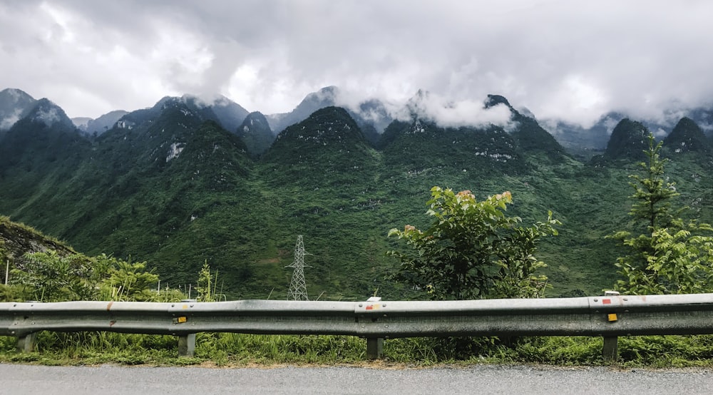 green trees and mountain under white clouds during daytime