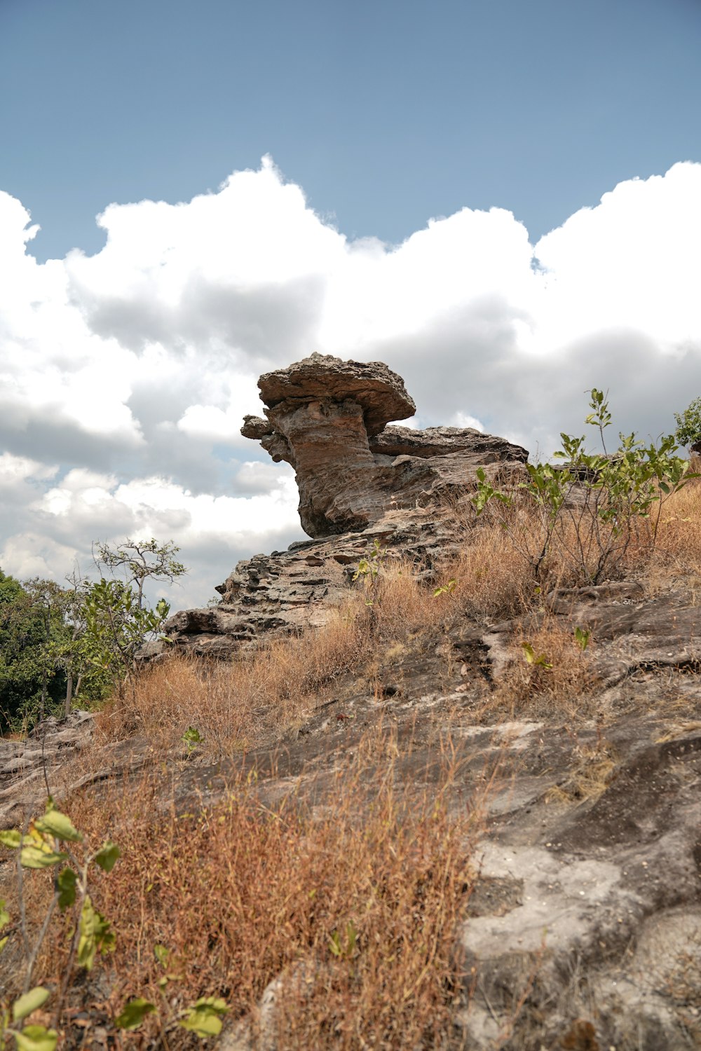 brown rock formation under white clouds during daytime