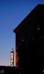 Evening shot of the hotel exterior lit warmly against a sunset sky.