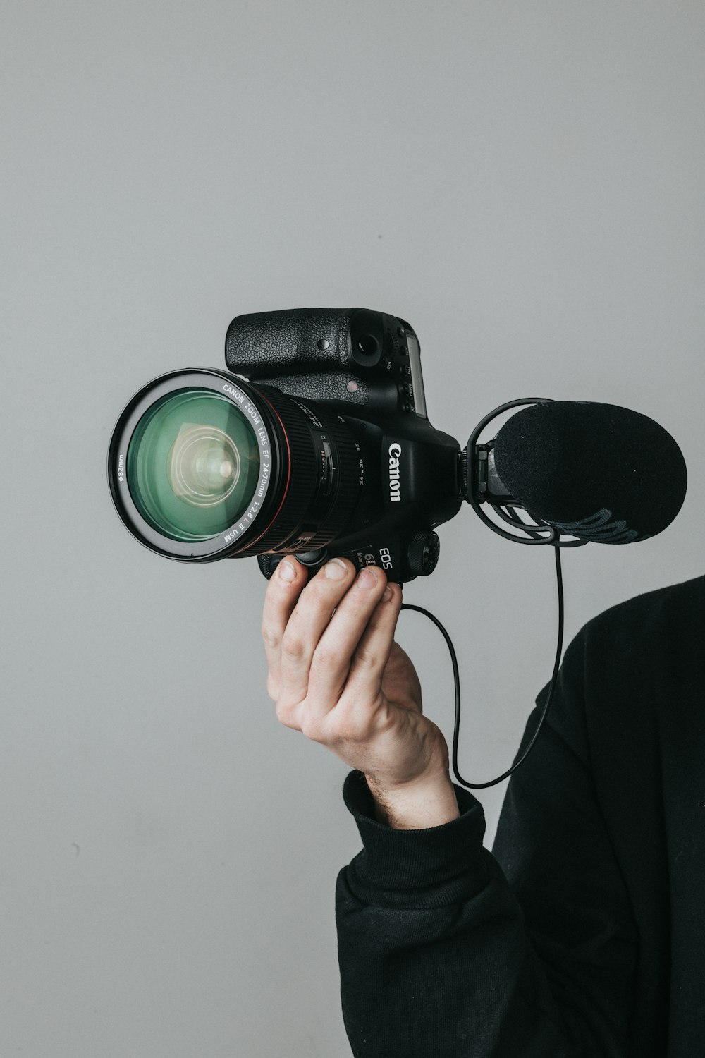 person holding black dslr camera