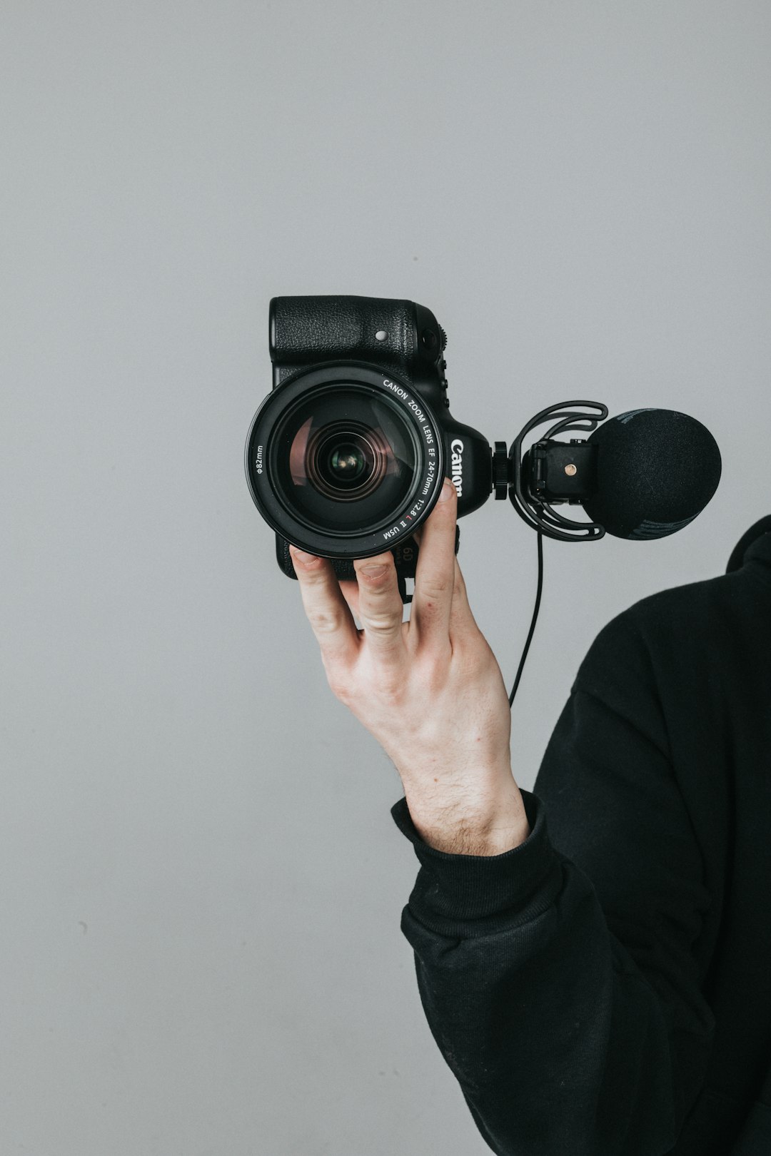 person holding black dslr camera