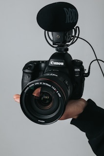 black nikon dslr camera on persons hand