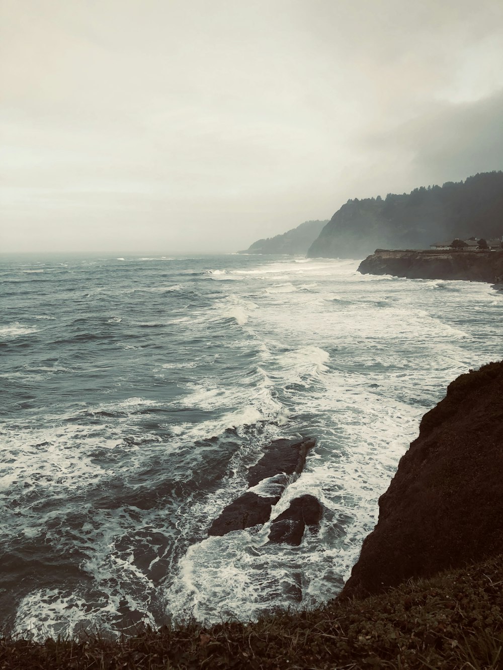 brown rock formation beside body of water during daytime