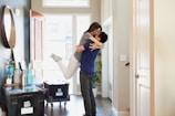 woman in gray long sleeve shirt and gray pants standing beside white wooden door