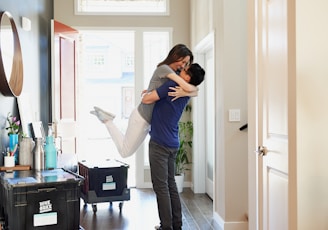 woman in gray long sleeve shirt and gray pants standing beside white wooden door