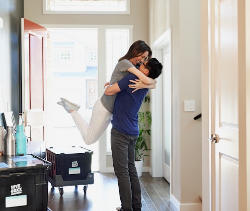 woman in gray long sleeve shirt and gray pants standing beside white wooden door