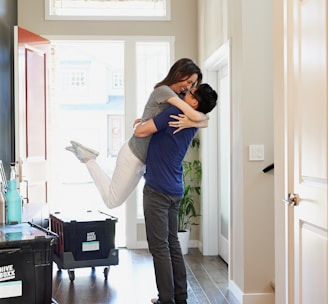 woman in gray long sleeve shirt and gray pants standing beside white wooden door