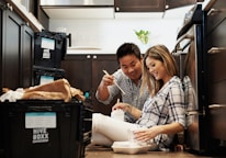 A family happily unpacking in their new home.