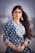 woman in blue and white floral long sleeve shirt
