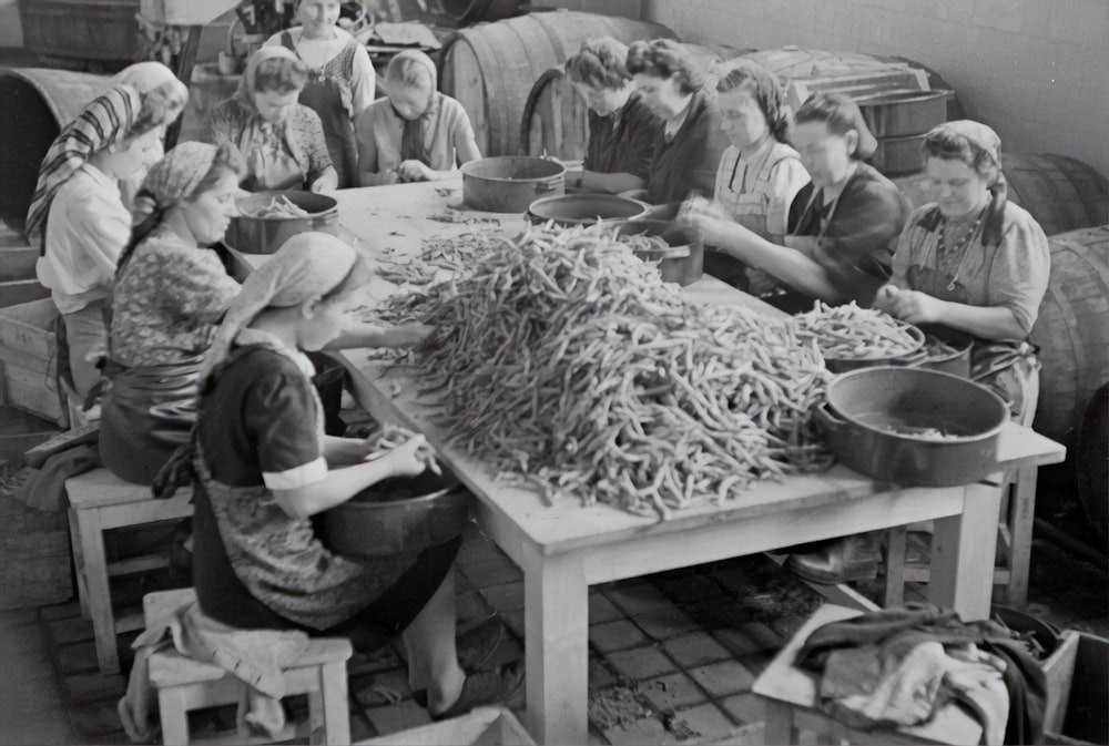 grayscale photo of people sitting on chair