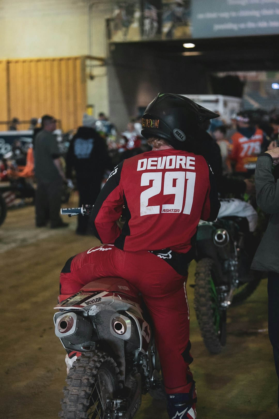 man in red and white power ranger costume riding motorcycle