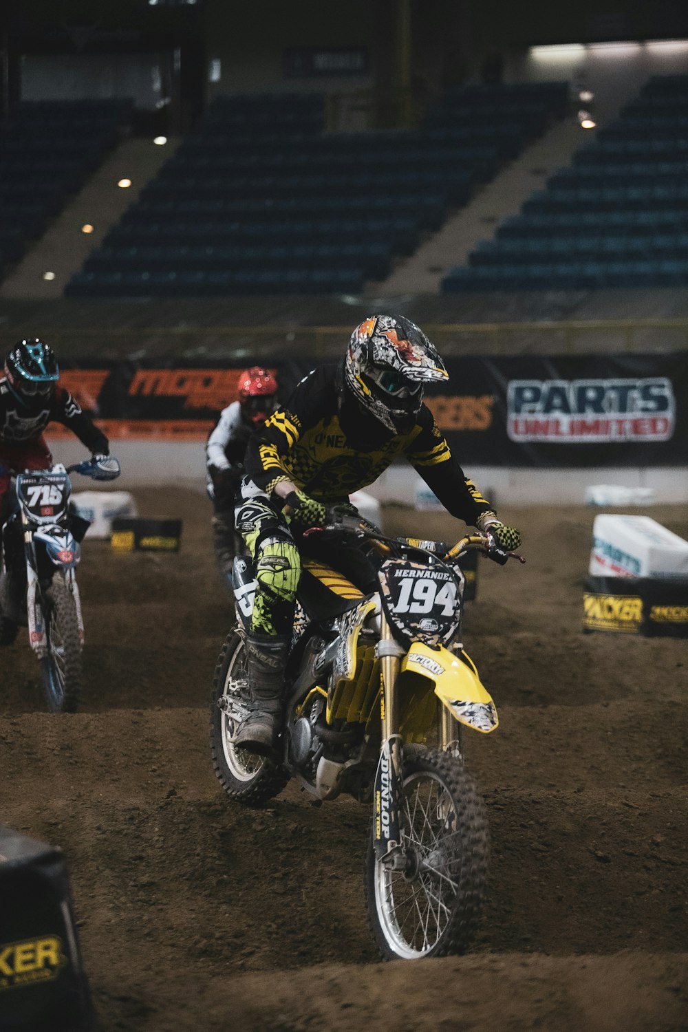 man in black and white motorcycle suit riding on white and black motocross dirt bike