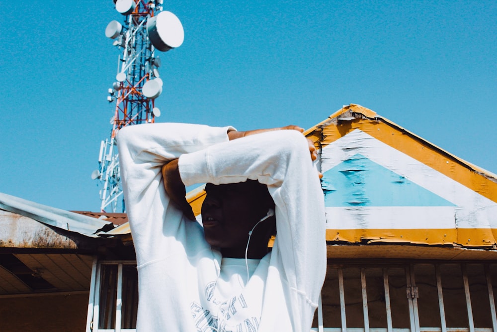 white and black long sleeve shirt hanging on yellow metal bar