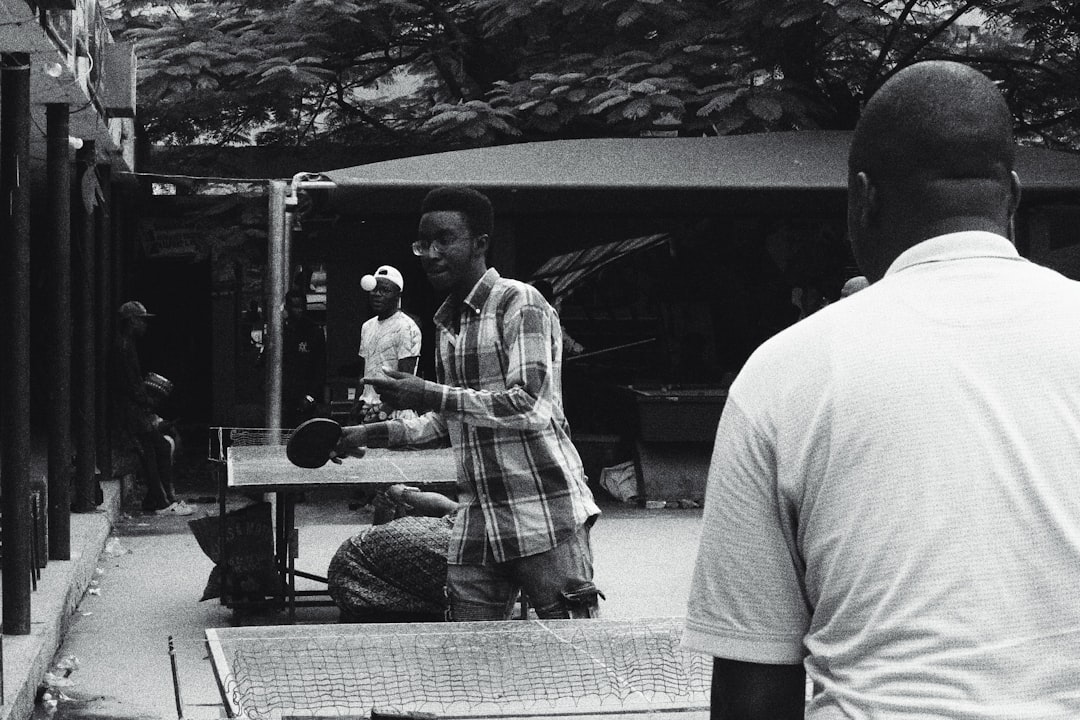 man in white shirt standing beside man in white shirt