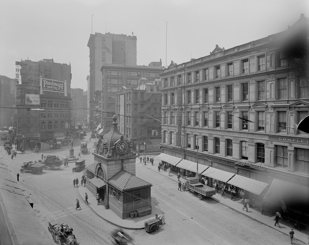 grayscale photo of cars on road near buildings