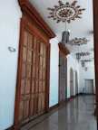 Hallway of the hotel with old-fashioned lamps and wooden doors