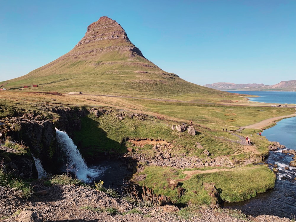 a mountain with a waterfall in the middle of it