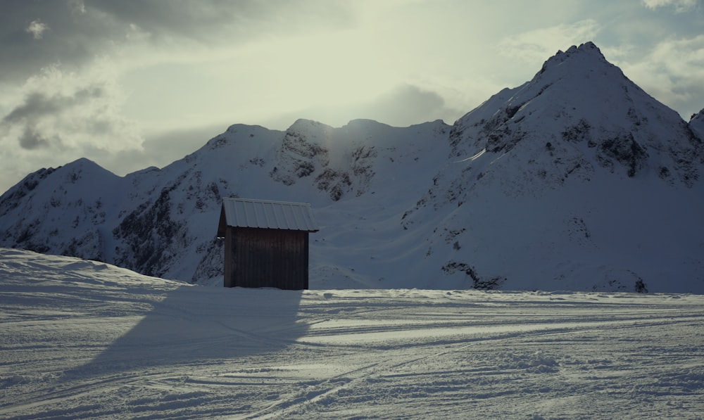 brown wooden house on snow covered ground