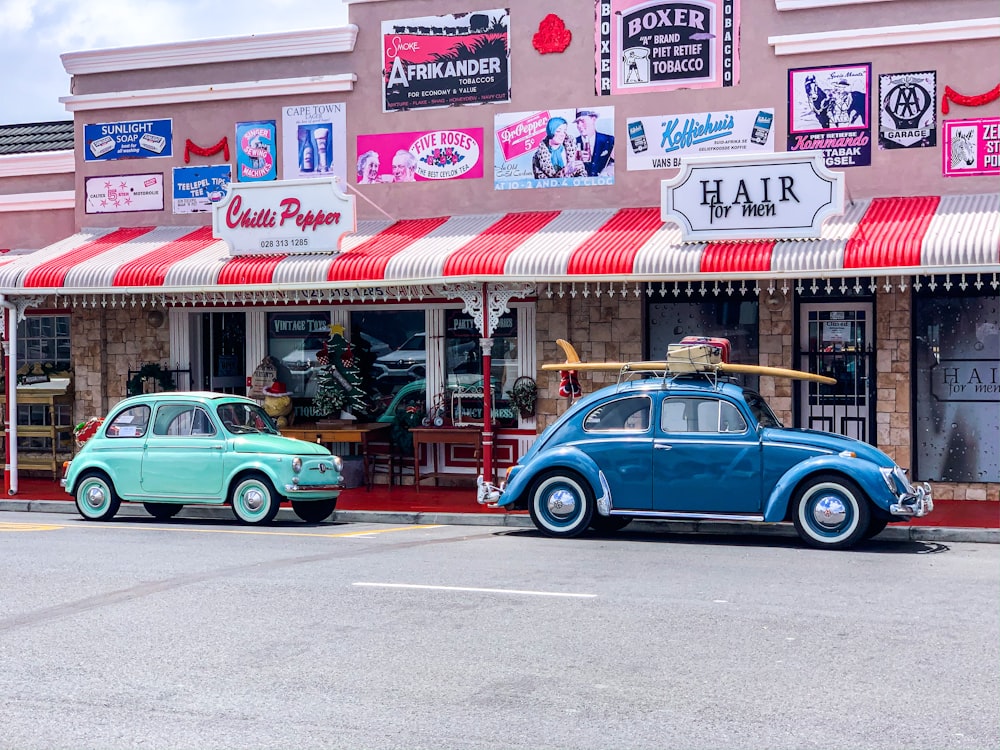 teal sedan parked in front of store during daytime