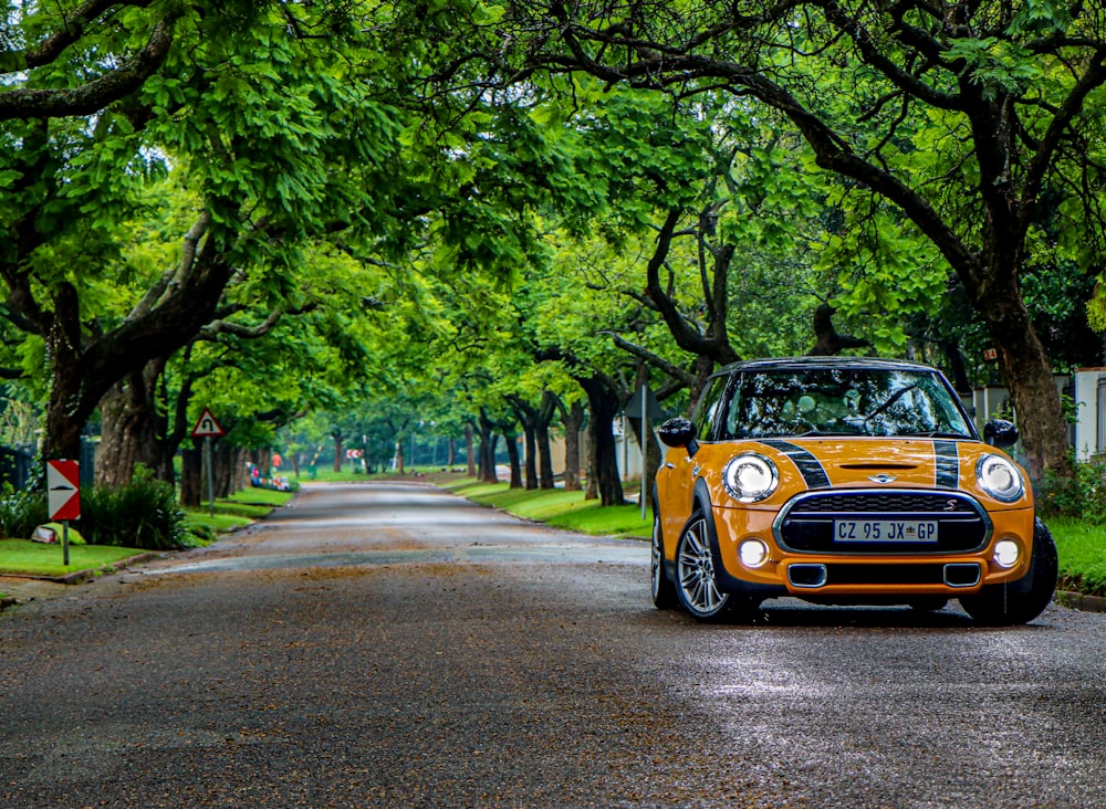 yellow and black porsche 911 on road during daytime