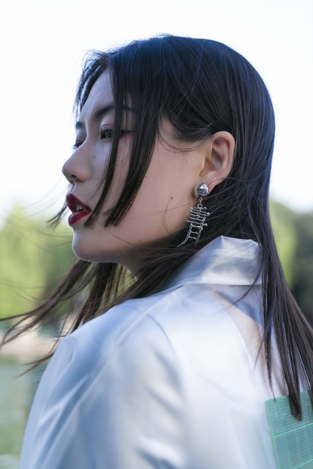 woman in white shirt wearing silver earrings