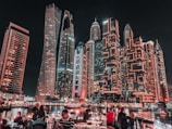 people in front of brown high rise building during nighttime