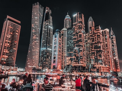 people in front of brown high rise building during nighttime