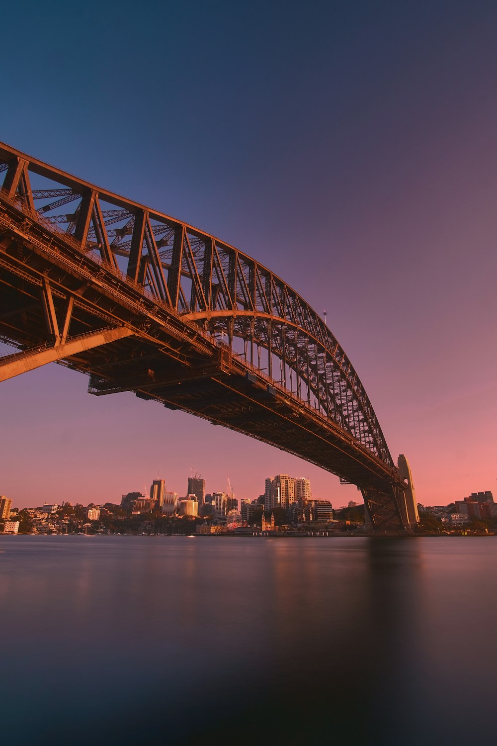 brown metal bridge over body of water during daytime