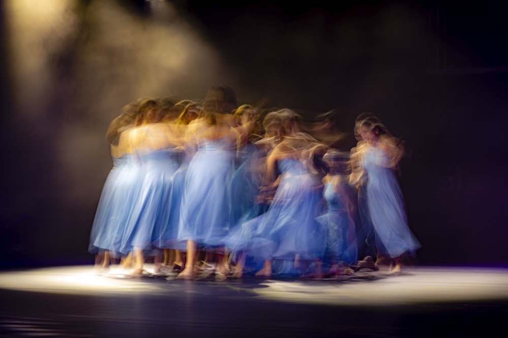 group of women in white dress dancing on stage