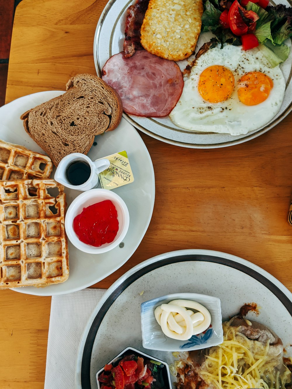 waffle with egg and ham on white ceramic plate