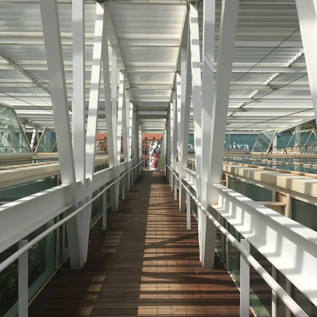 A sleek PRFV pultruded pedestrian bridge bathed in natural sunlight.