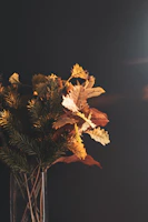 Seasonal wooden flower bouquet featuring autumn colors, set against a backdrop of fallen leaves.