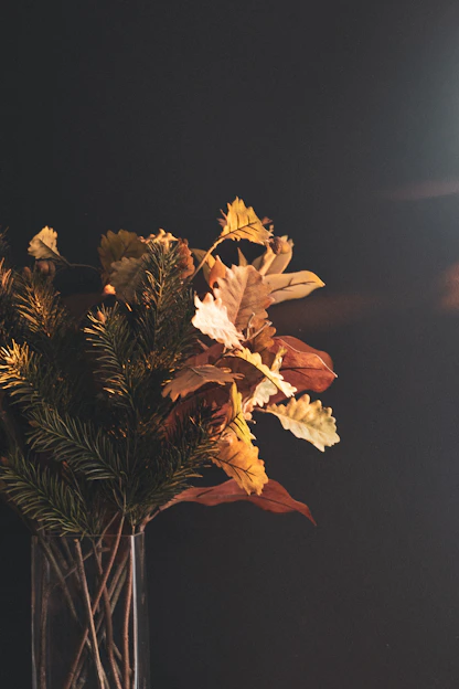 A bright bouquet of assorted seasonal flowers from Autumn and Petals, artfully arranged in a chic vase against a soft, warm background.